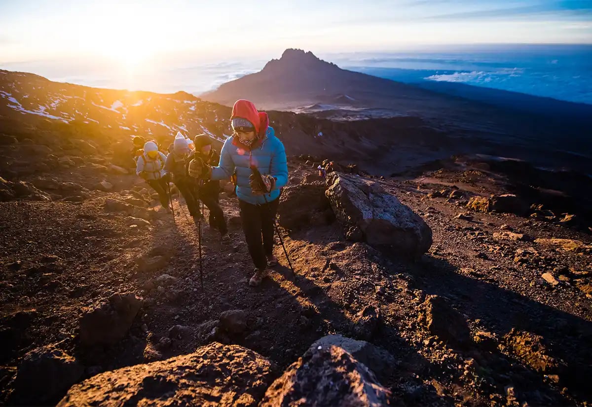 People hiking a mountain during sunset January