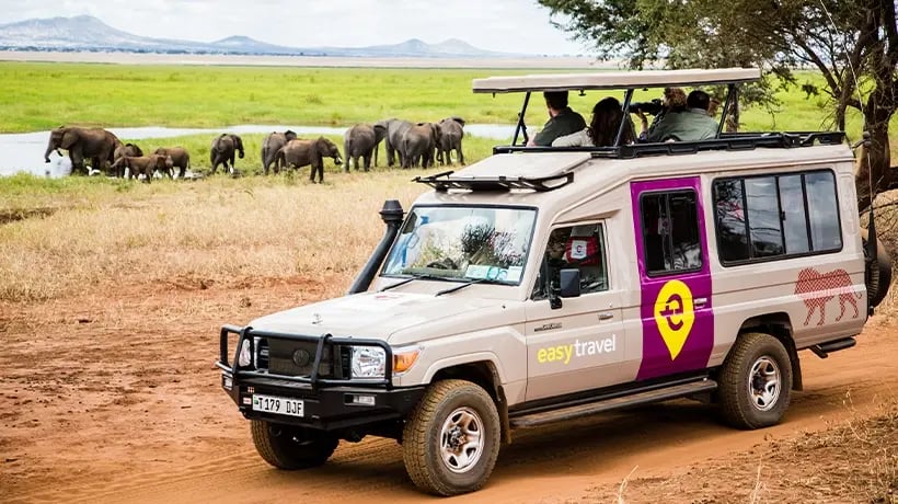 Safari Truck in front of elephant in the river